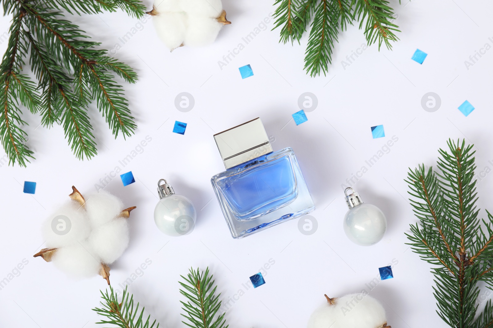 Photo of Christmas composition with perfume bottle on white background, flat lay