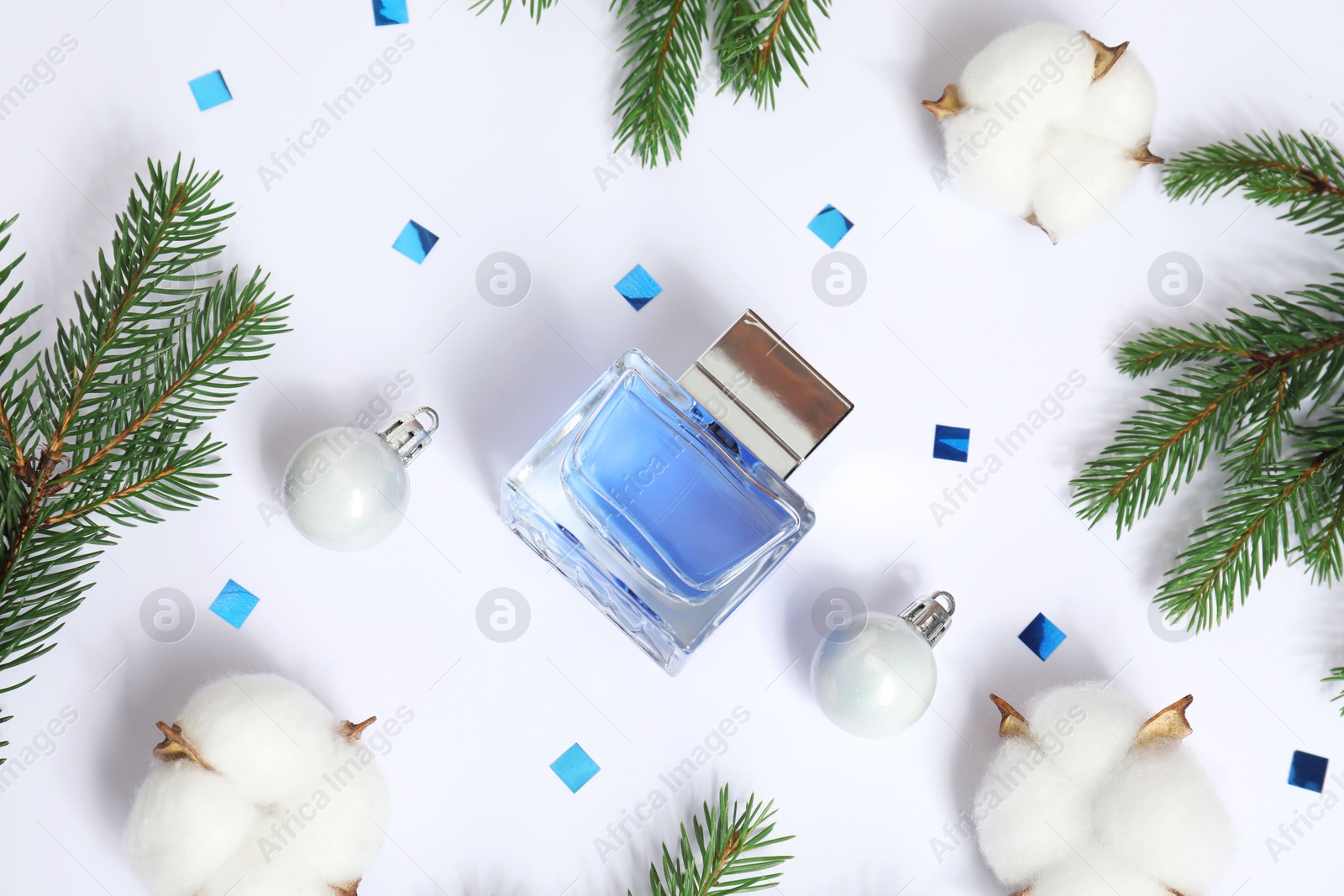 Photo of Christmas composition with perfume bottle on white background, flat lay