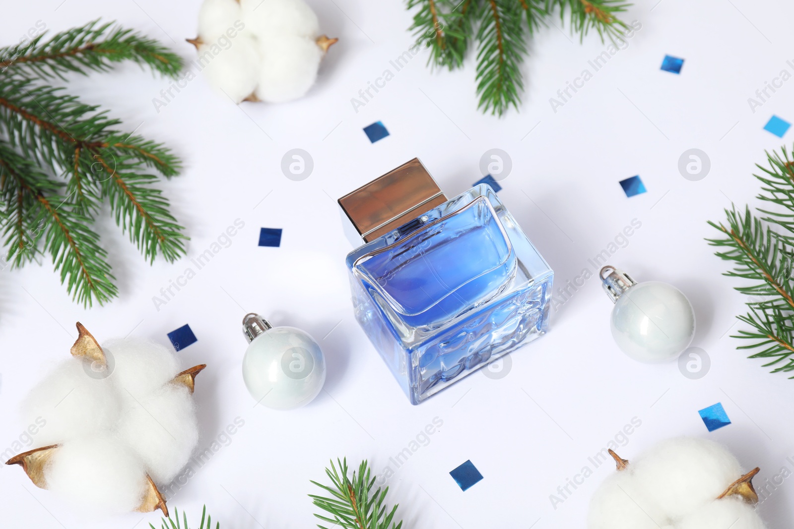 Photo of Composition with perfume bottle and Christmas decor on white background