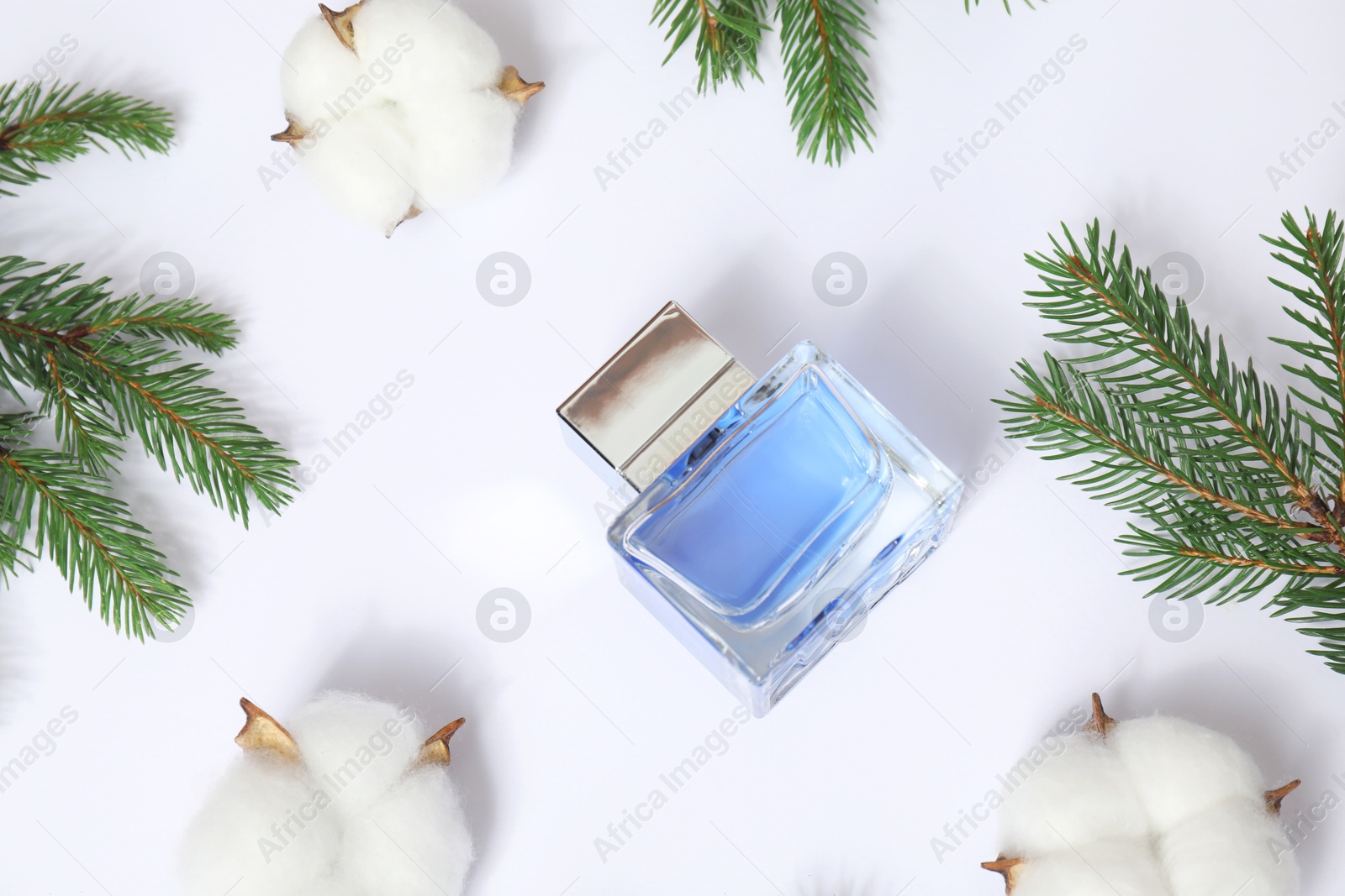 Photo of Christmas composition with perfume bottle on white background, flat lay