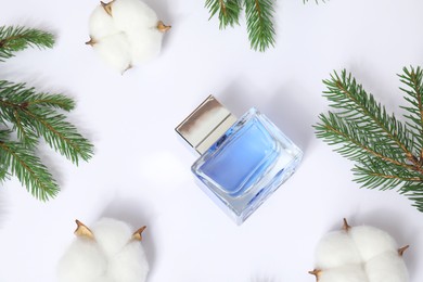 Christmas composition with perfume bottle on white background, flat lay