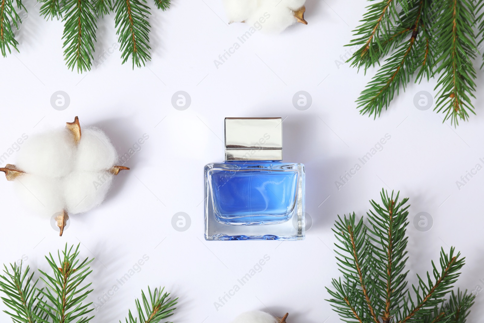 Photo of Christmas composition with perfume bottle on white background, flat lay