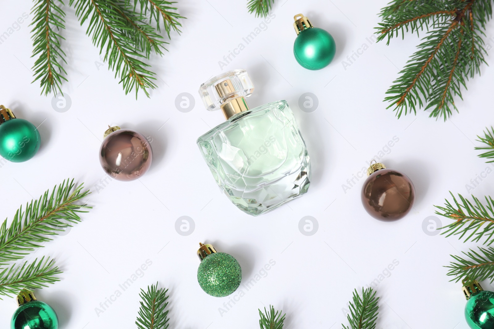 Photo of Christmas composition with perfume bottle on white background, flat lay