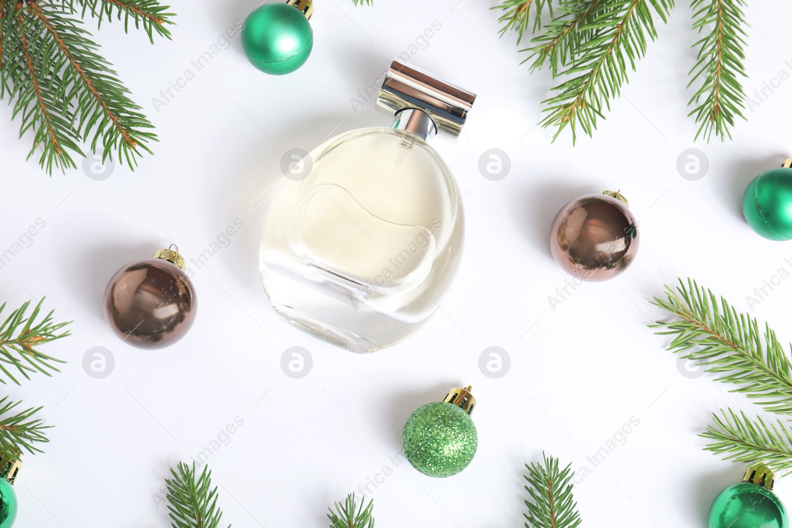 Photo of Christmas composition with perfume bottle on white background, flat lay