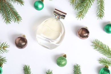 Christmas composition with perfume bottle on white background, flat lay