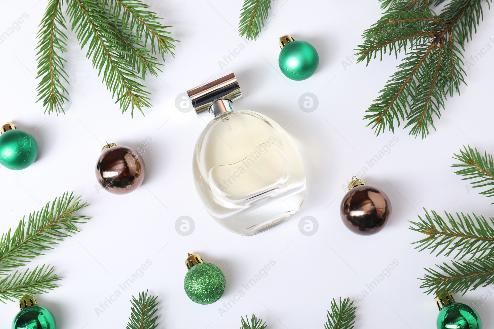 Photo of Christmas composition with perfume bottle on white background, flat lay