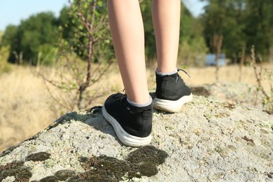 Little boy travelling outdoors on sunny day, closeup