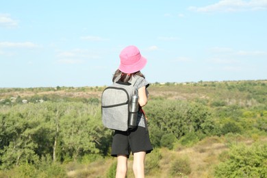 Photo of Little girl enjoying picturesque landscape, back view