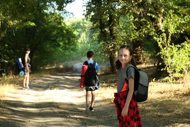 Little girl travelling with her family in beautiful forest