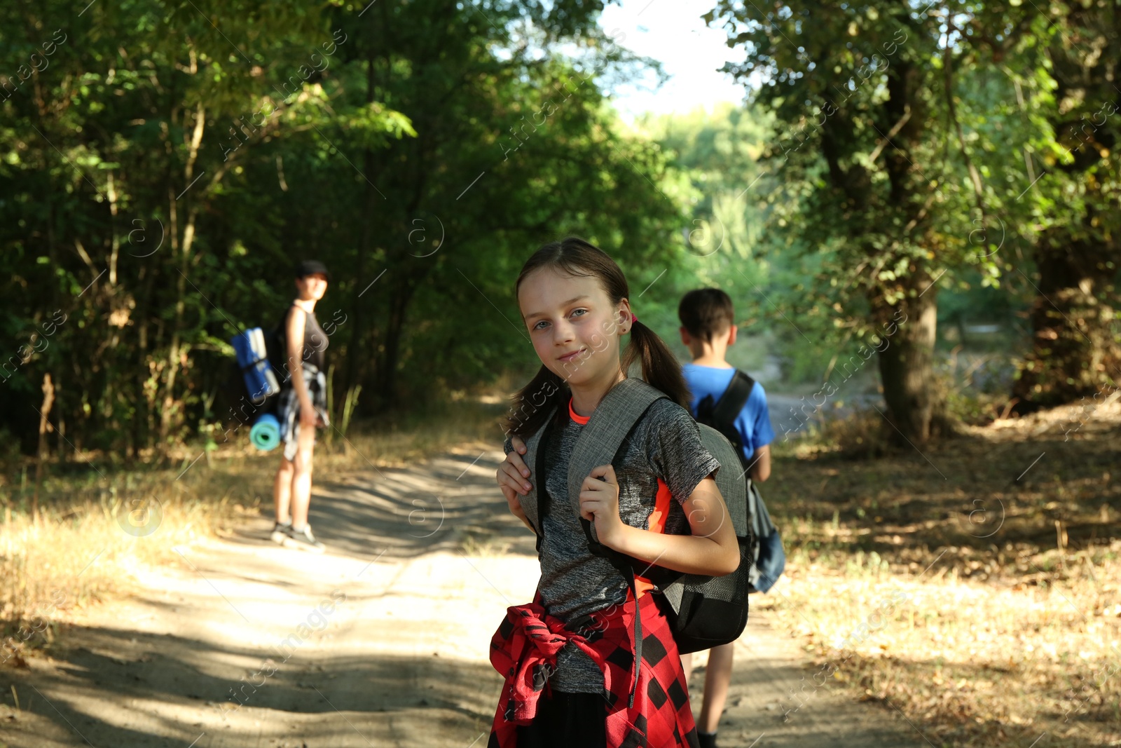 Photo of Little girl travelling with her family in beautiful forest