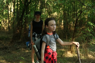 Photo of Portrait of little girl travelling with her mother in beautiful forest