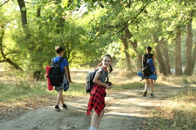 Photo of Little girl travelling with her family in beautiful forest