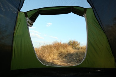 Photo of Beautiful blue sky and grass, view from camping tent