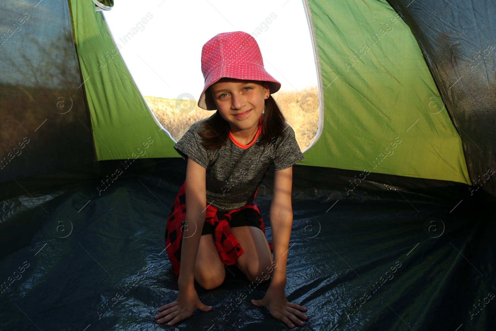 Photo of Cute little girl in camping tent. Active tourism