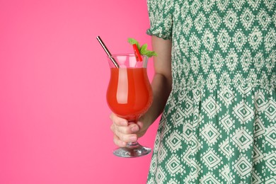 Photo of Woman with glass of refreshing cocktail on pink background, closeup. Space for text