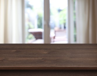 Image of Empty wooden table near window with curtains. Space for design