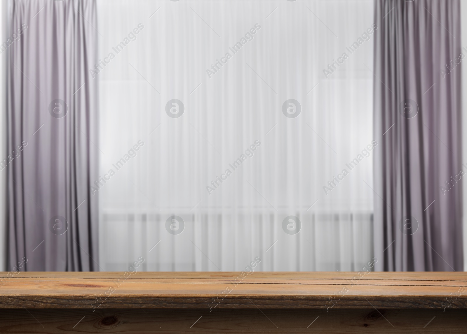 Image of Empty wooden table near window with curtains. Space for design