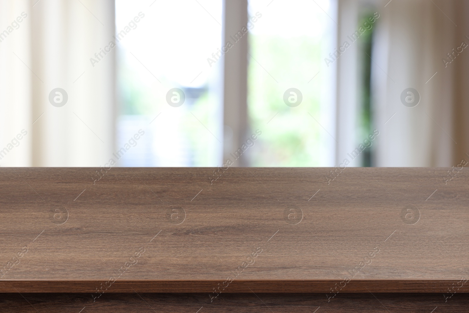 Image of Empty wooden table near window with curtains. Space for design