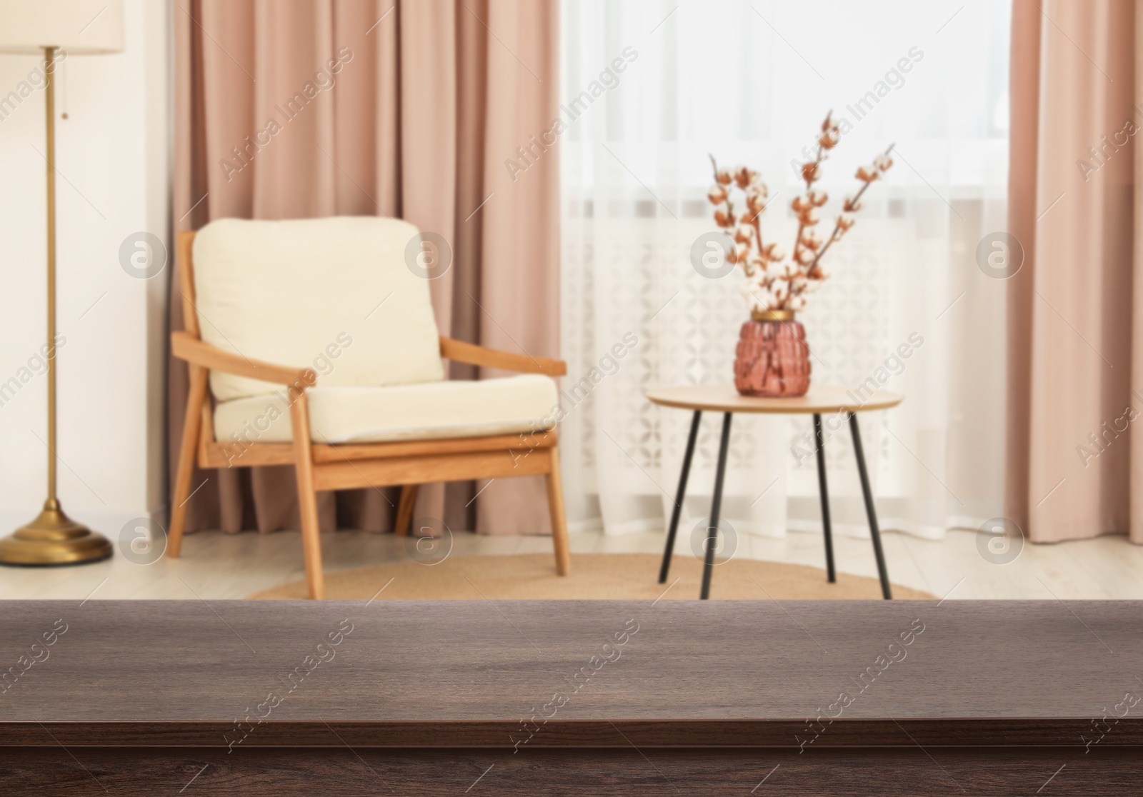 Image of Empty wooden table near armchair, side table and window with curtains. Space for design