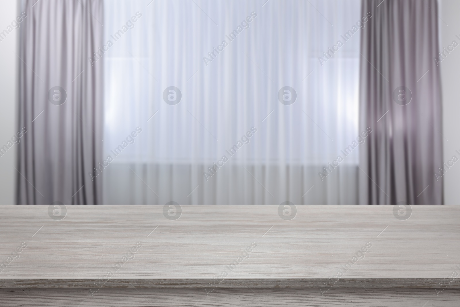 Image of Empty white wooden table near window with curtains. Space for design