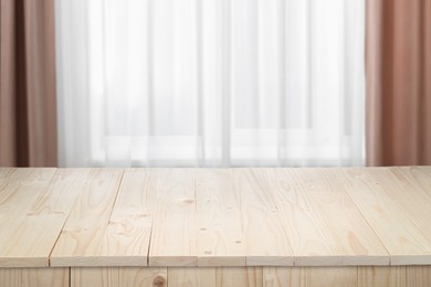 Image of Empty white wooden table near window with curtains. Space for design