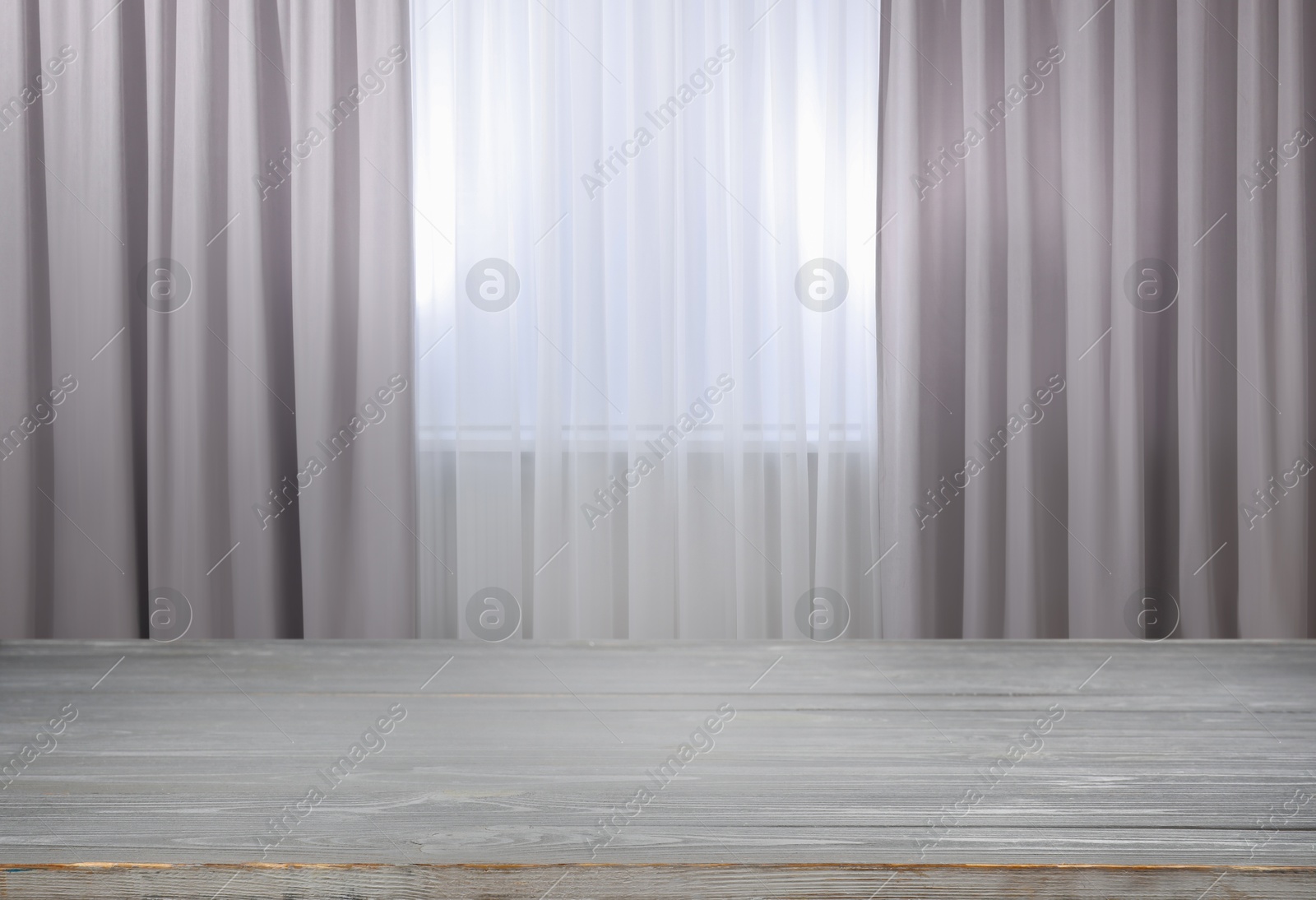 Image of Empty wooden table near window with curtains. Space for design