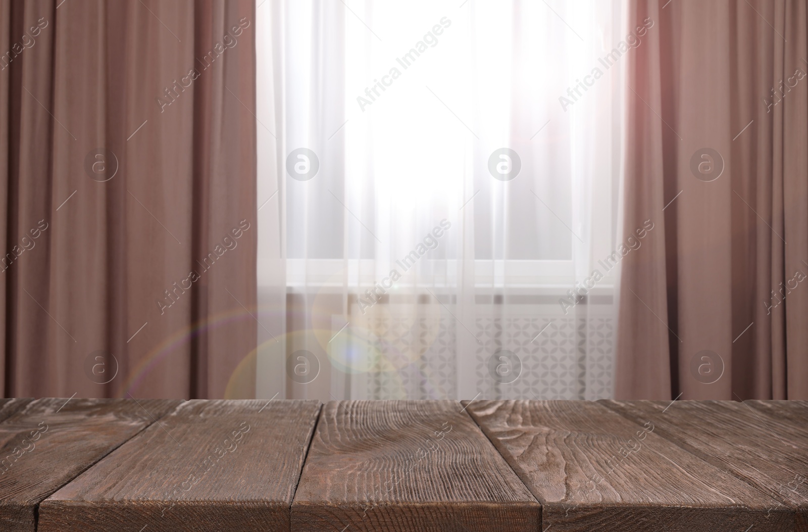 Image of Empty wooden table near window with curtains. Space for design