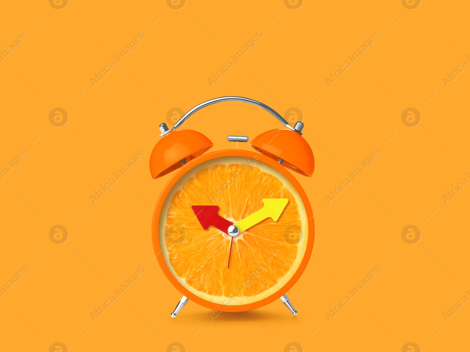 Image of Juicy orange on alarm clock dial against orange background. Creative poster