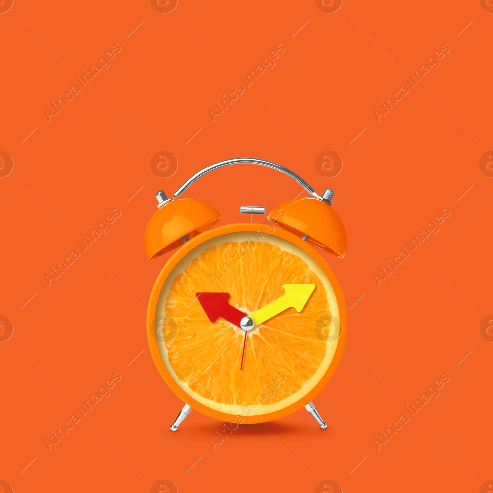 Image of Juicy orange on alarm clock dial against dark orange background. Creative poster