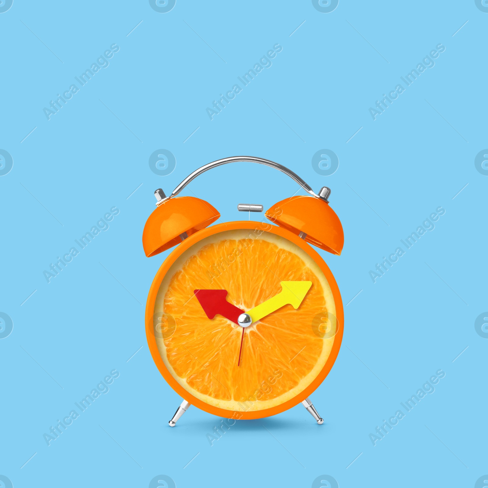 Image of Juicy orange on alarm clock dial against light blue background. Creative poster