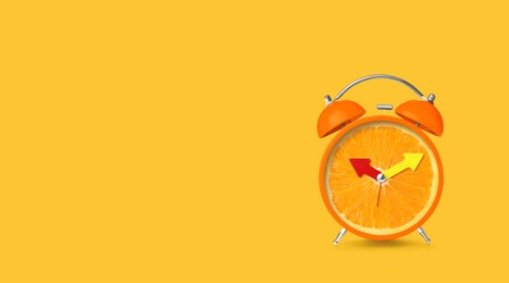 Image of Juicy orange on alarm clock dial against golden background. Creative poster with space for text, banner design