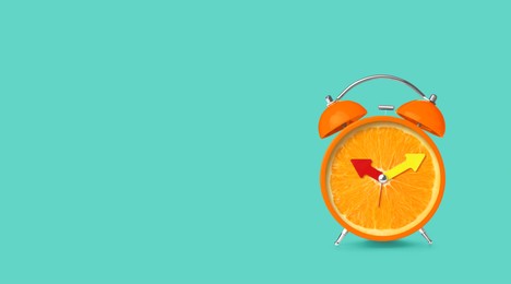 Image of Juicy orange on alarm clock dial against turquoise background. Creative poster with space for text, banner design