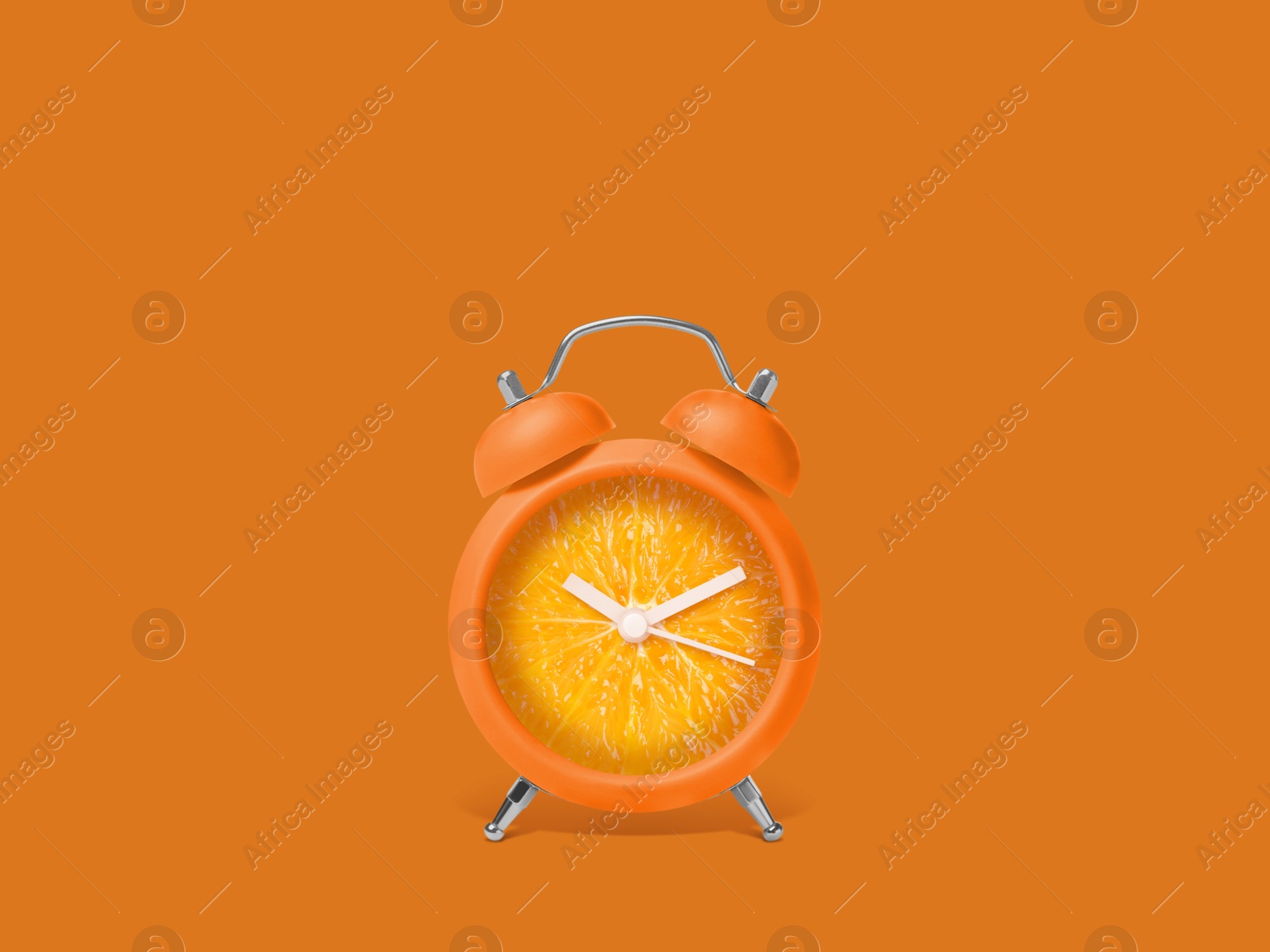 Image of Juicy orange on alarm clock dial against dark orange background. Creative poster