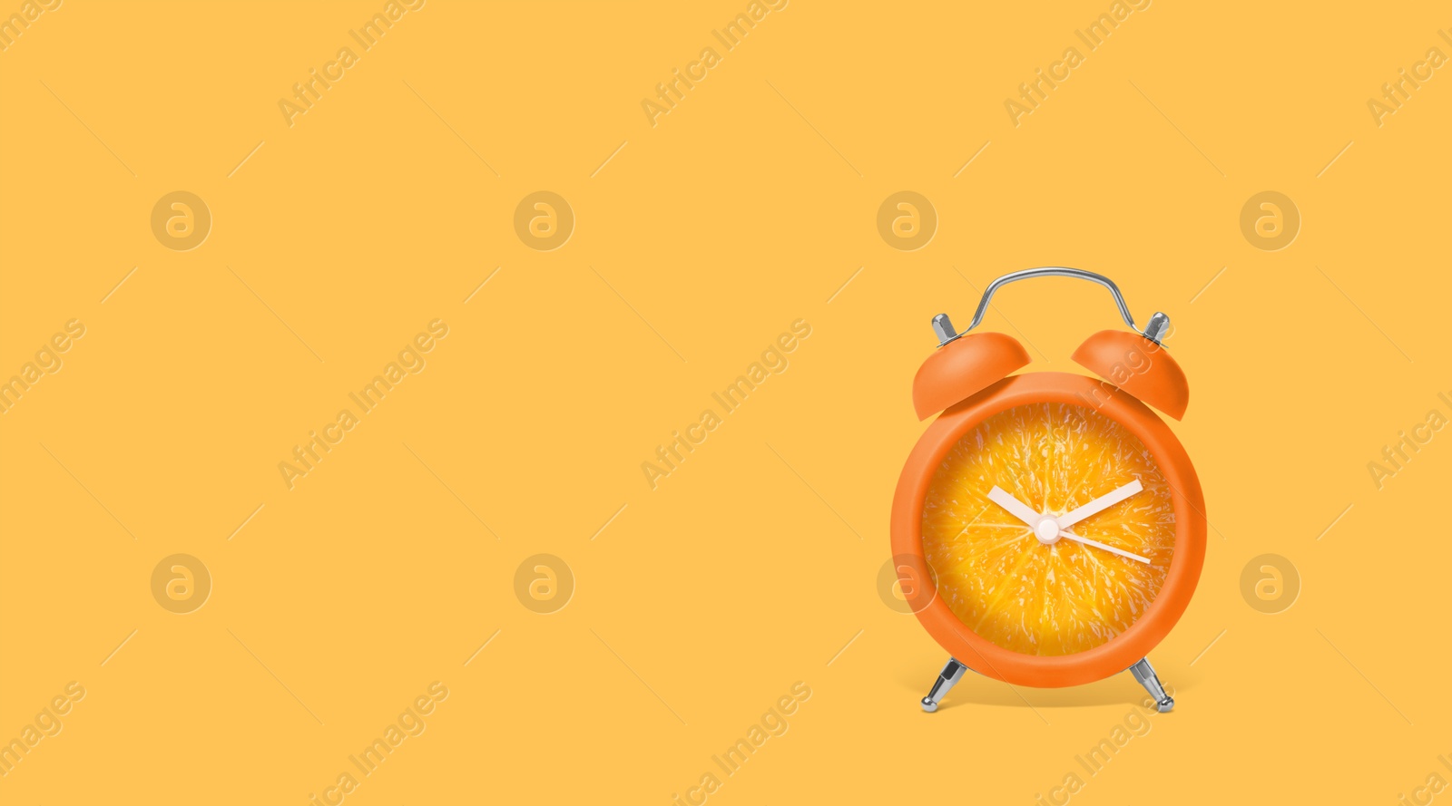 Image of Juicy orange on alarm clock dial against light orange background. Creative poster with space for text, banner design