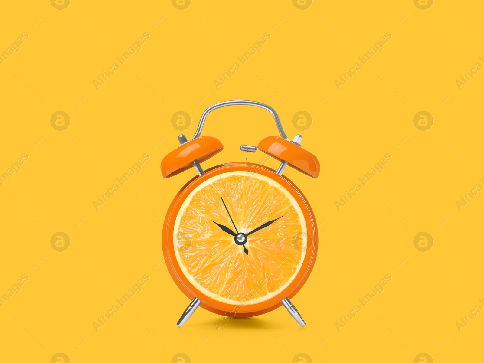 Image of Juicy orange on alarm clock dial against golden background. Creative poster