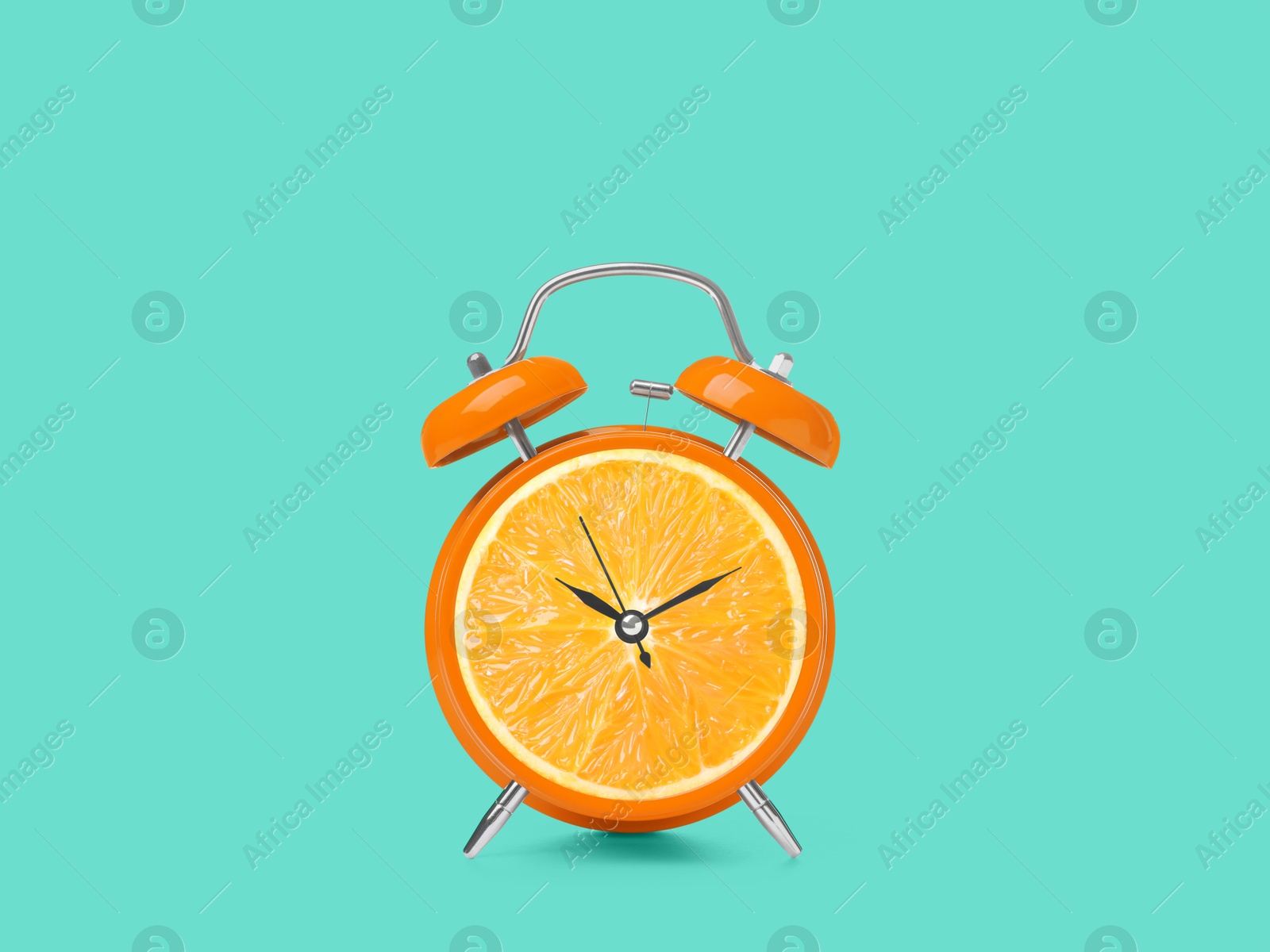 Image of Juicy orange on alarm clock dial against turquoise background. Creative poster