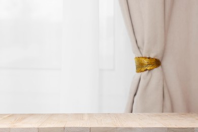 Image of Empty white wooden table near window with curtains. Space for design