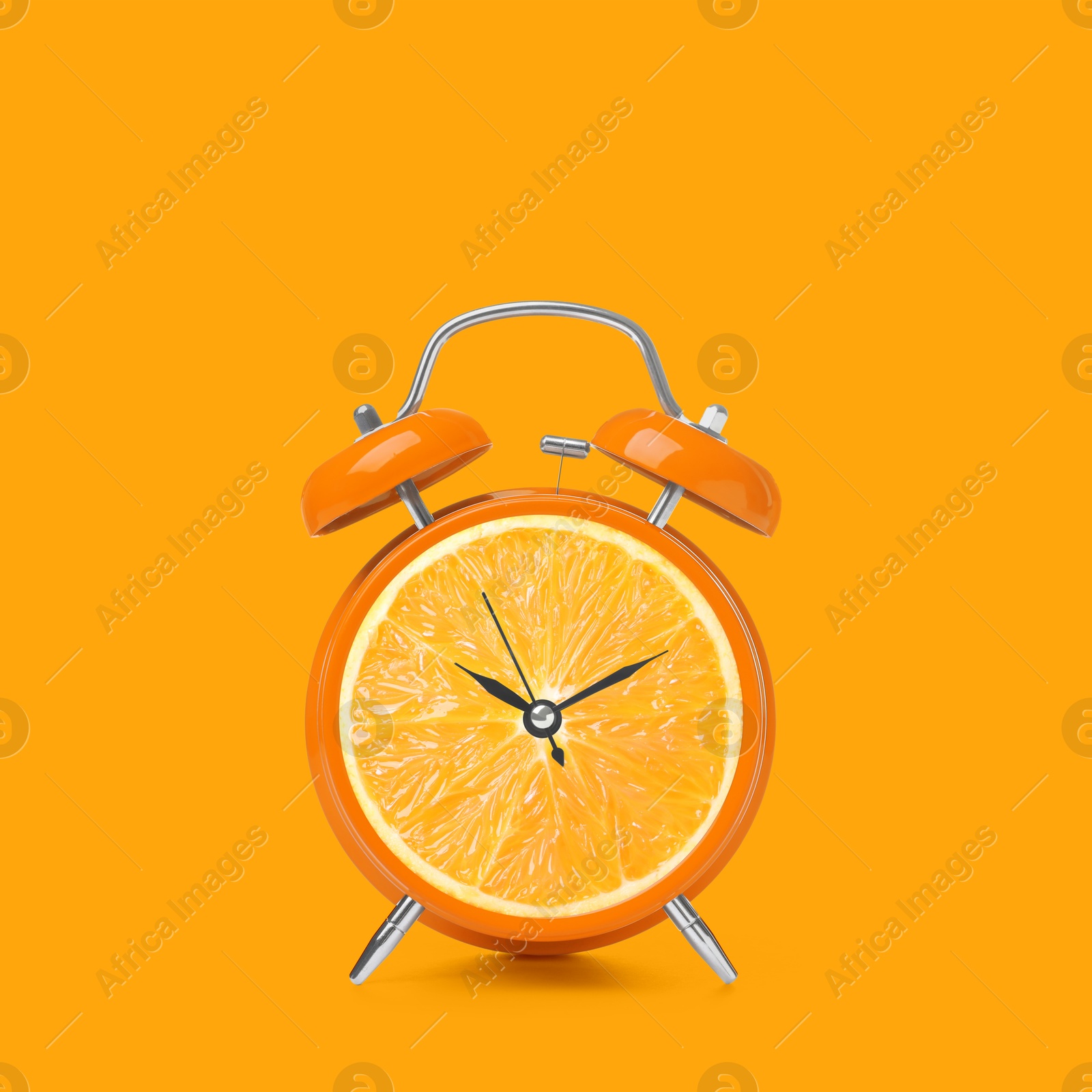 Image of Juicy orange on alarm clock dial against orange background. Creative poster