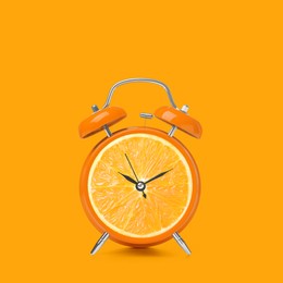 Image of Juicy orange on alarm clock dial against orange background. Creative poster