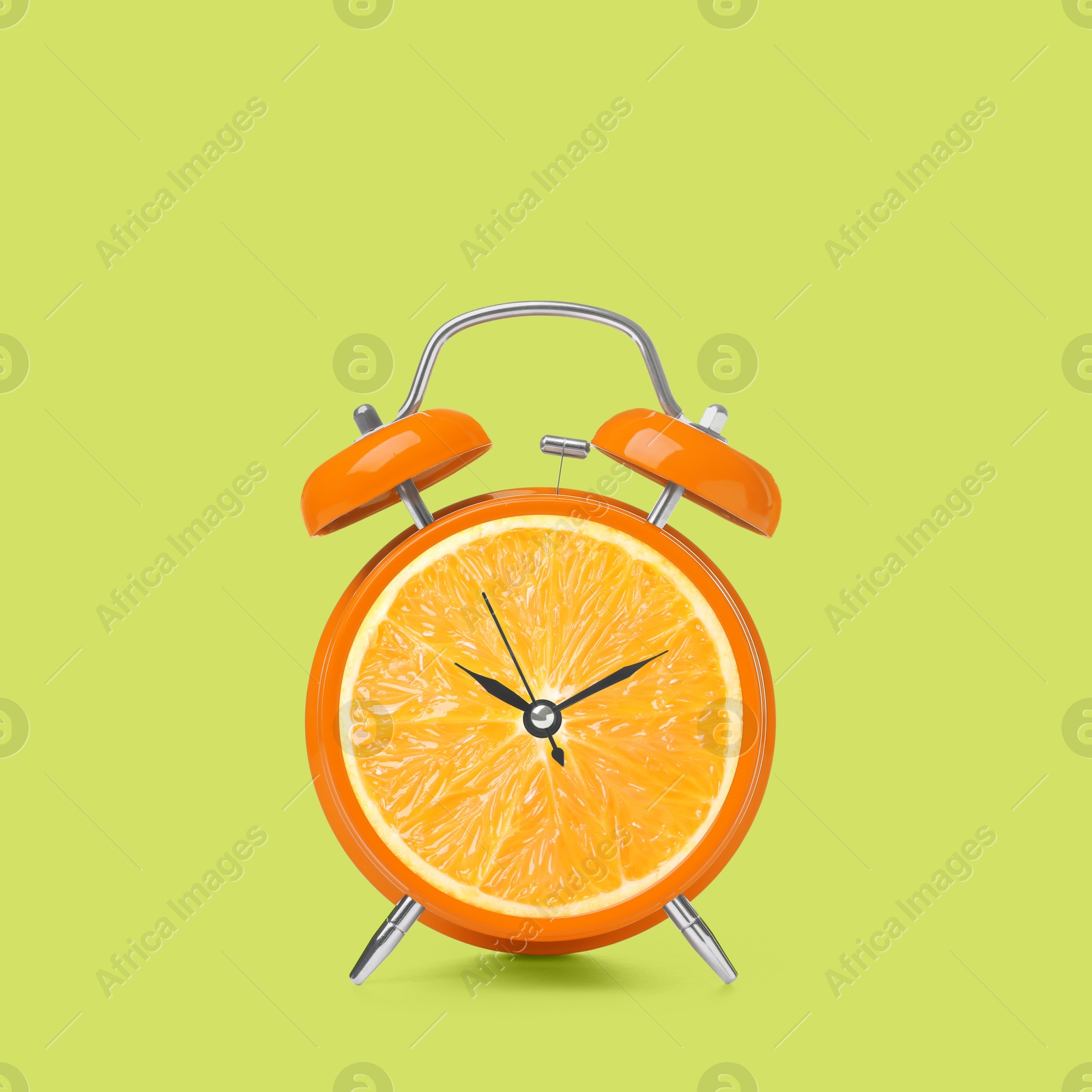 Image of Juicy orange on alarm clock dial against light green background. Creative poster