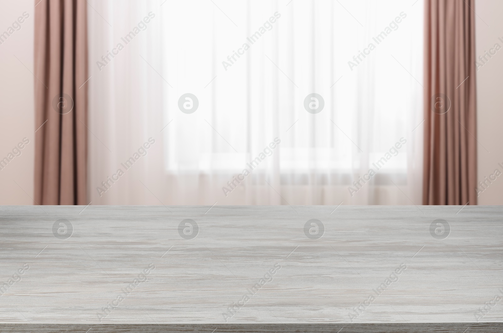 Image of Empty white wooden table near window with curtains. Space for design