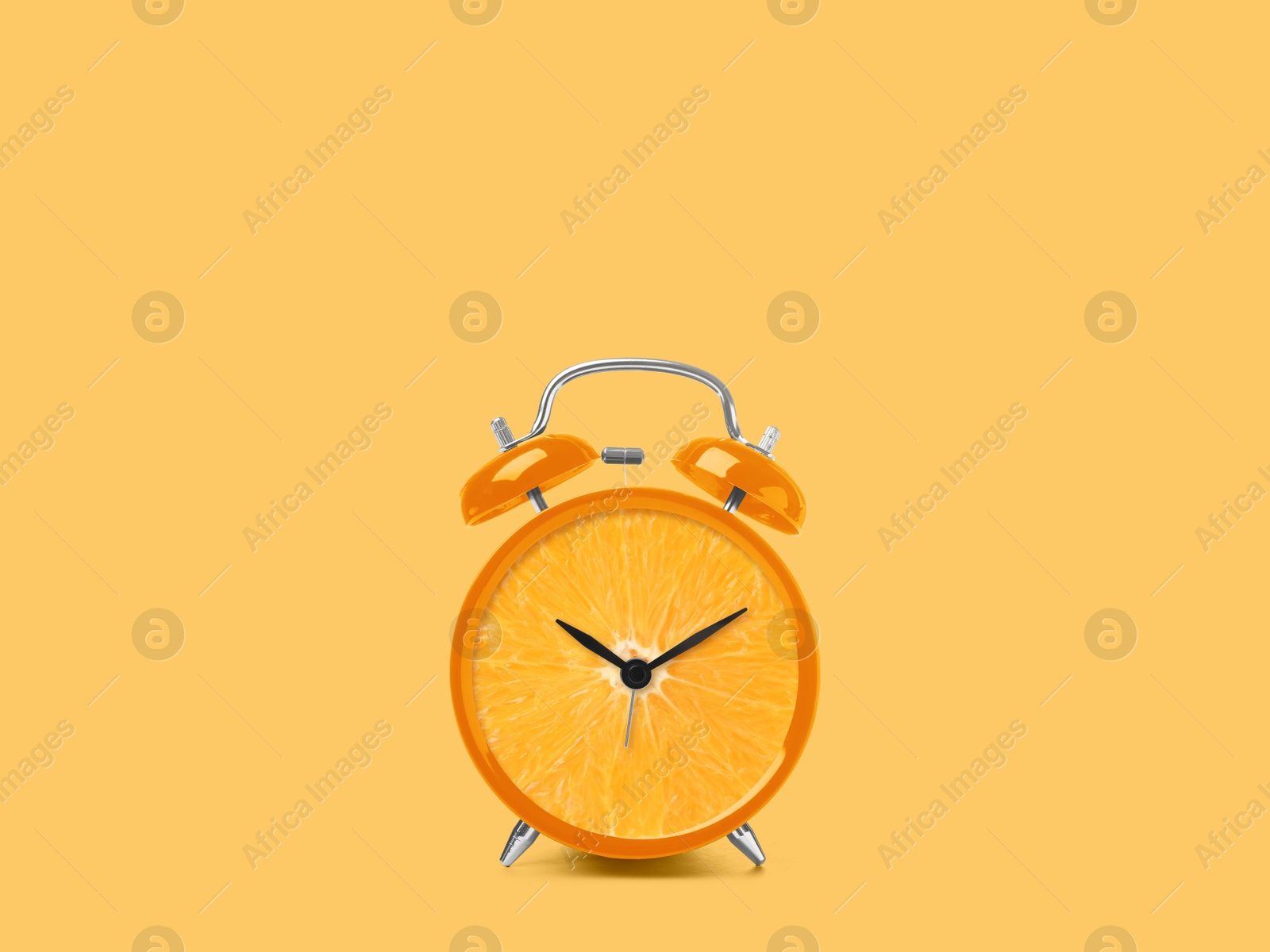 Image of Juicy orange on alarm clock dial against light orange background. Creative poster