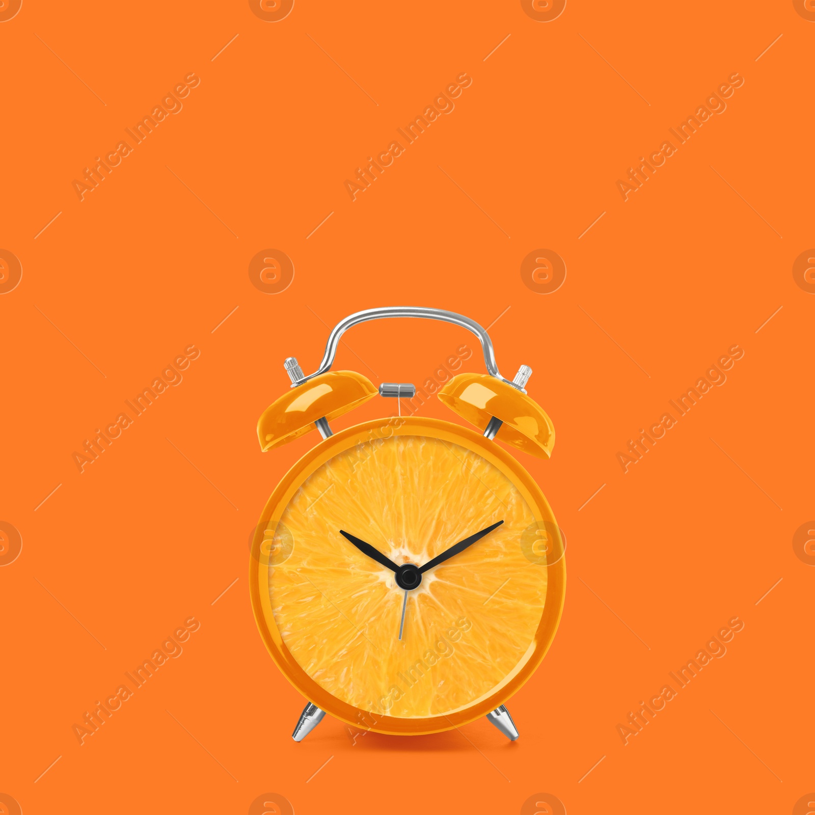 Image of Juicy orange on alarm clock dial against dark orange background. Creative poster