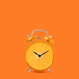 Juicy orange on alarm clock dial against dark orange background. Creative poster