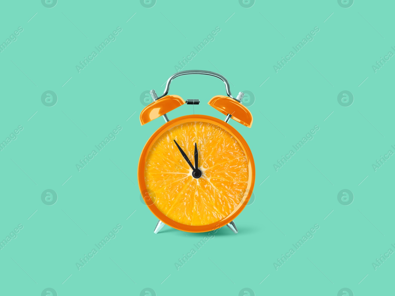 Image of Juicy orange on alarm clock dial against turquoise background. Creative poster