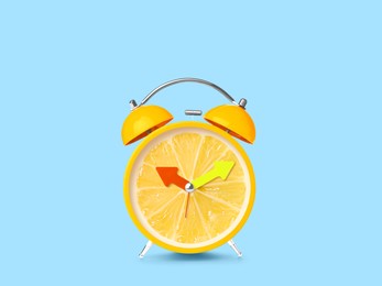 Juicy lemon on alarm clock dial against light blue background. Creative poster