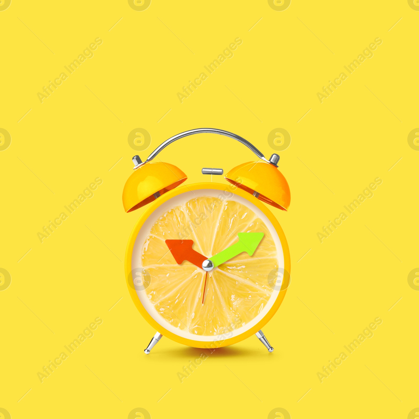 Image of Juicy lemon on alarm clock dial against yellow background. Creative poster