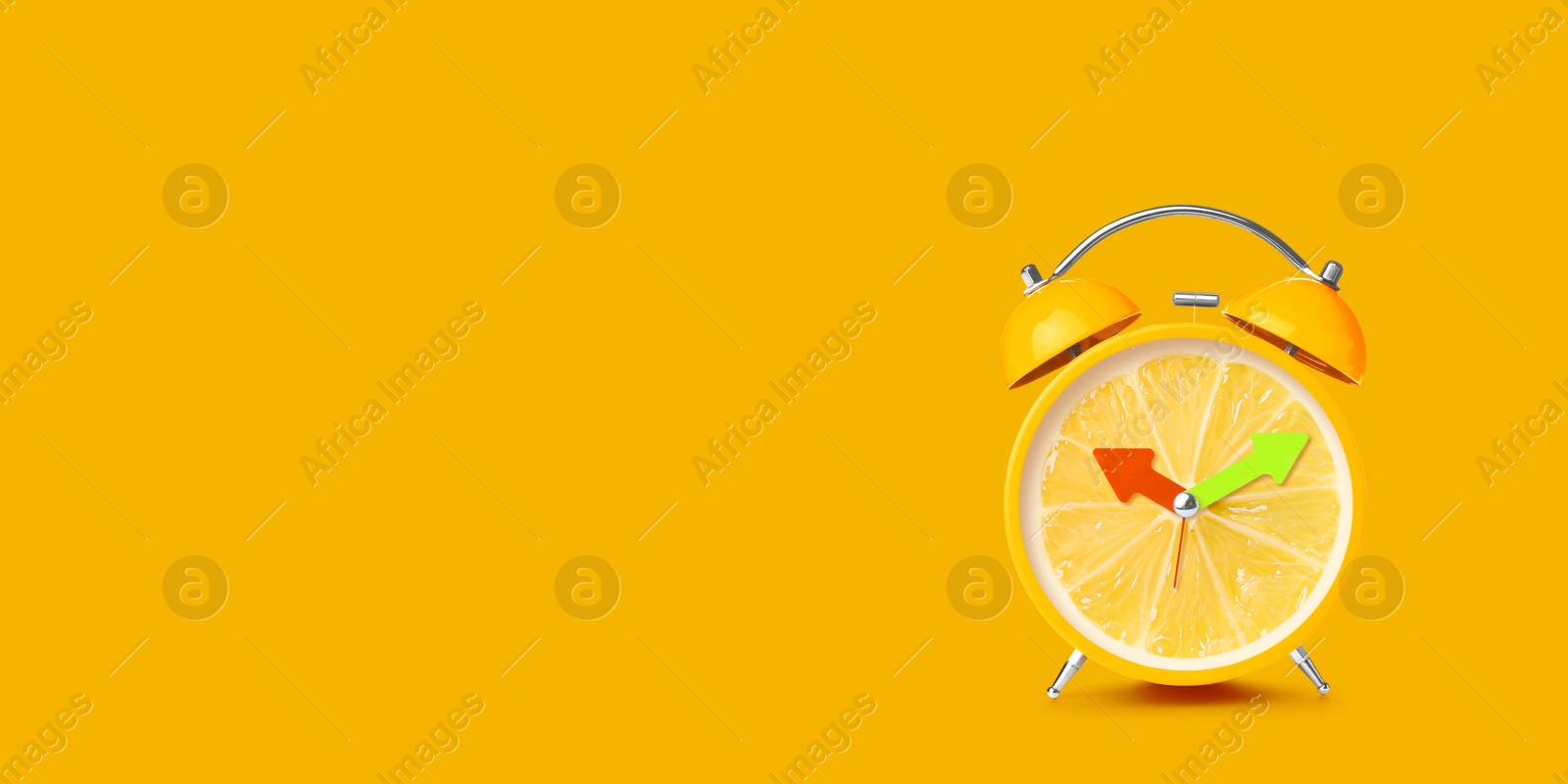 Image of Juicy lemon on alarm clock dial against orange background. Creative poster with space for text, banner design