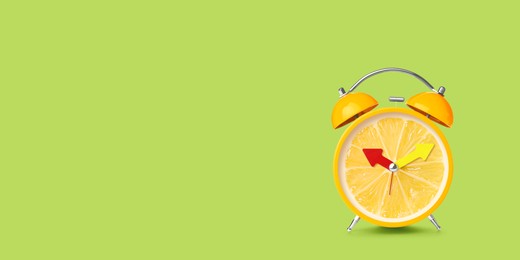 Image of Juicy lemon on alarm clock dial against light green background. Creative poster with space for text, banner design