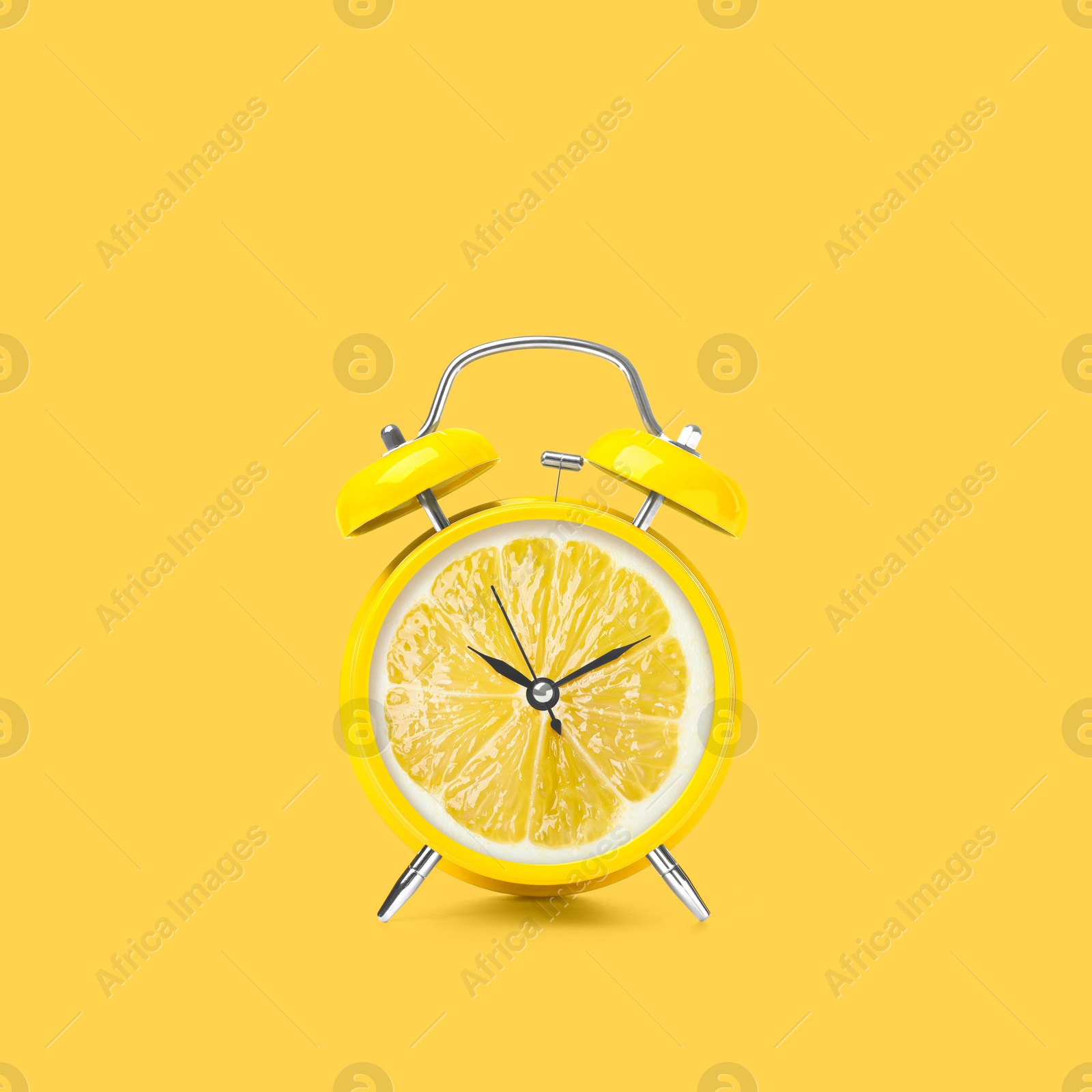 Image of Juicy lemon on alarm clock dial against yellow background. Creative poster